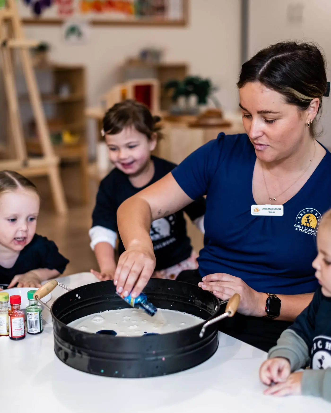 An educator and child exploring a sensory tray at Chinderah