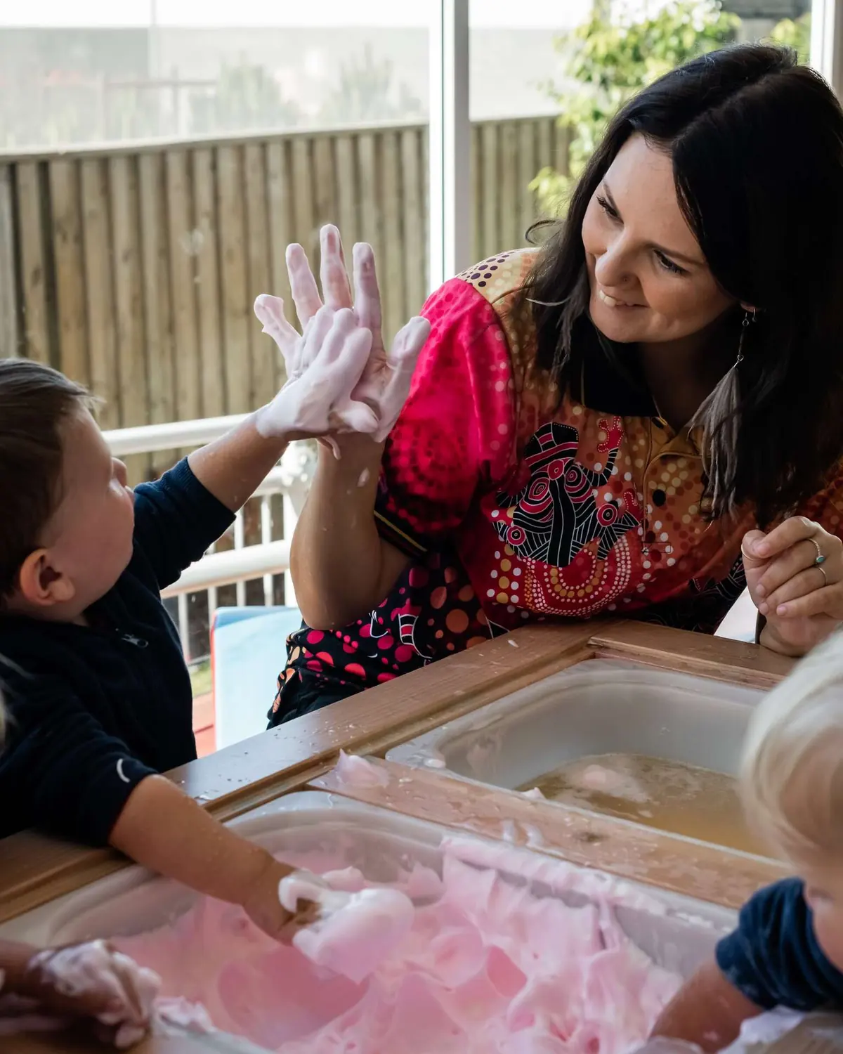 A child playing at the water and sensory table at Chinderah