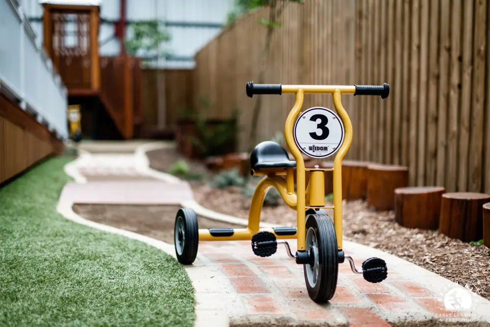 A child riding a trike on the bike track at Beach Kids Cabarita